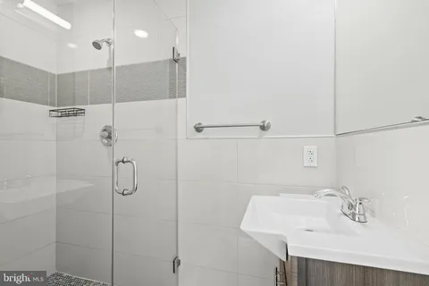 a bathroom with a sink and shower