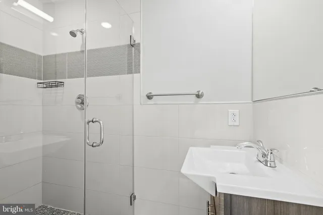 a bathroom with a sink and shower