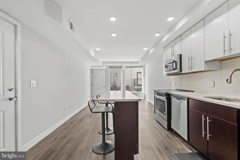 a kitchen with a sink appliances and cabinets