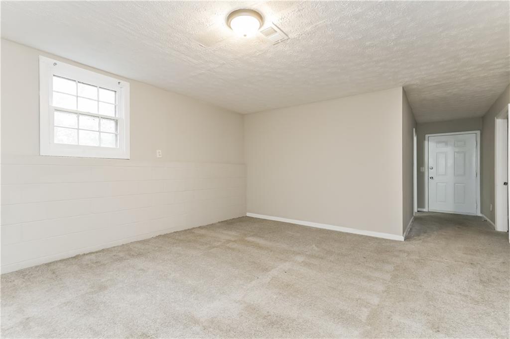 35 Knights Circle Covington, GA 30016 - Photo 11 of 28 an empty room with windows