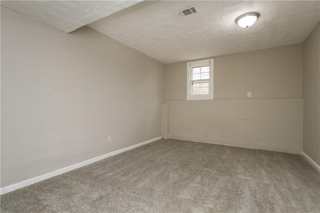 35 Knights Circle Covington, GA 30016 - Photo 14 of 28 an empty room with a window