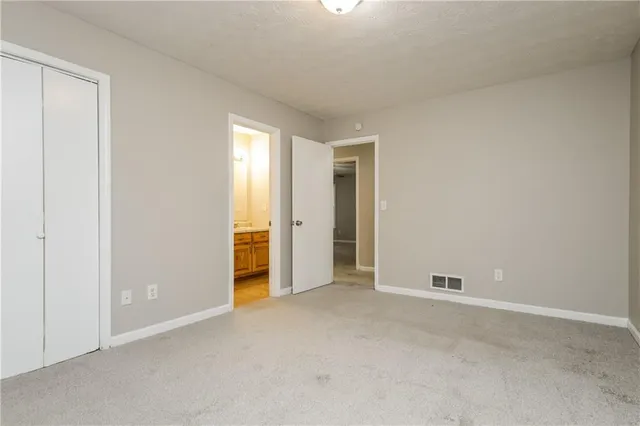 a view of an empty room and closet area