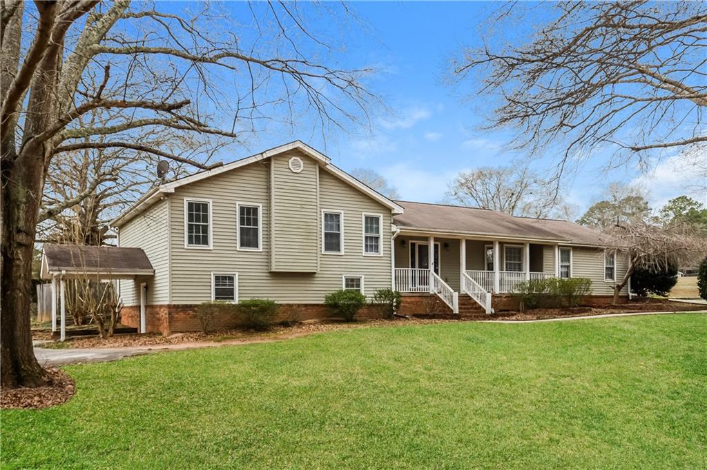 35 Knights Circle Covington, GA 30016 - Photo 24 of 28 a front view of a house with a garden and trees