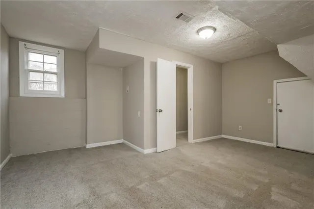 an empty room with windows and closet
