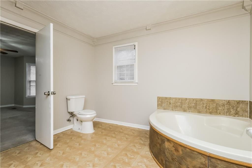 35 Knights Circle Covington, GA 30016 - Photo 10 of 28 a bathroom with a toilet and a bathtub