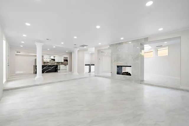 a view of kitchen with a sink and a large window in a living room