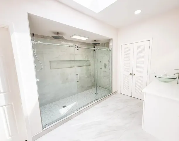 a bathroom with a shower and a sink