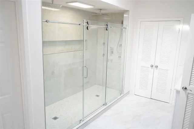 a bathroom with a glass shower door