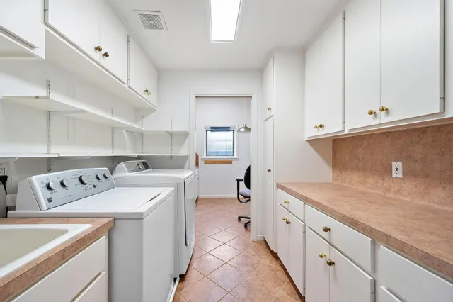 a kitchen with a sink and a stove top oven