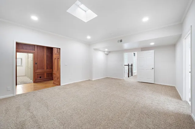 a view of empty room with a kitchen