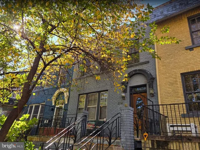 a front view of a house with iron fence