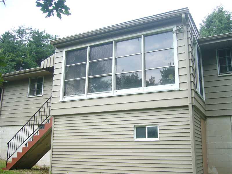 221 West Shaffer Road Aliquippa, PA 15001 - Photo 8 of 11 Exterior Back. This sunroom can offer a view for the morning coffee.