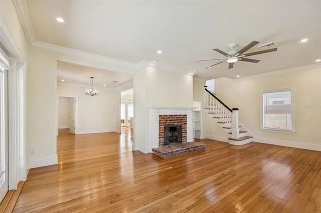 a view of a room with wooden floor and staircase