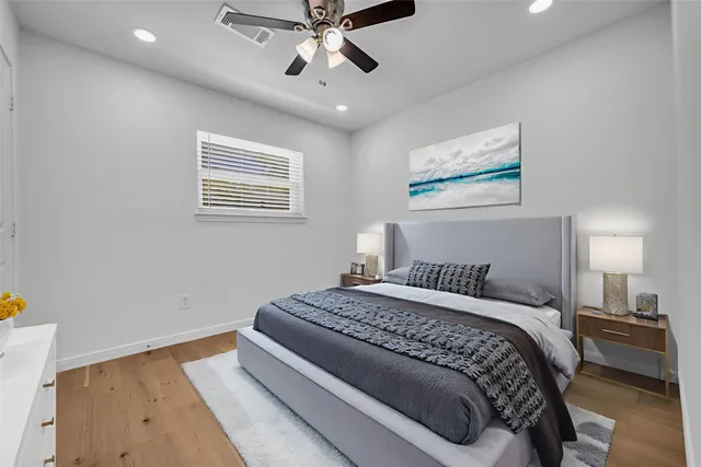 a bedroom with a large bed and a chandelier