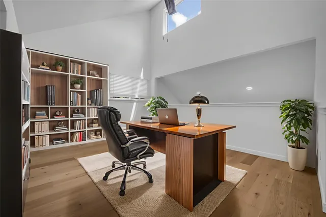 a view of a workspace with furniture and a potted plant