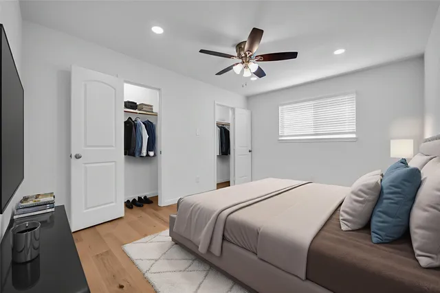 a bedroom with a bed furniture and a flat screen tv