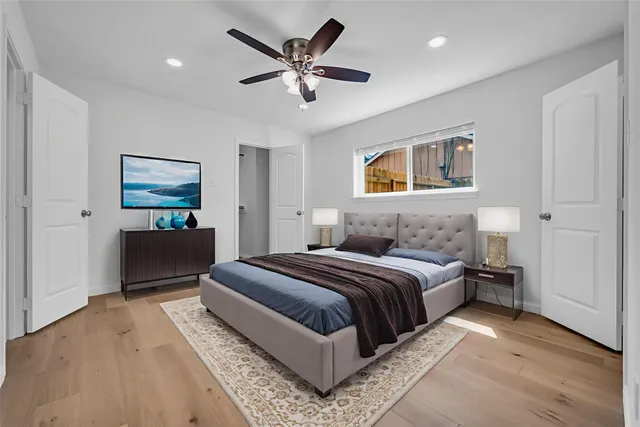 a bedroom with a bed and a chandelier