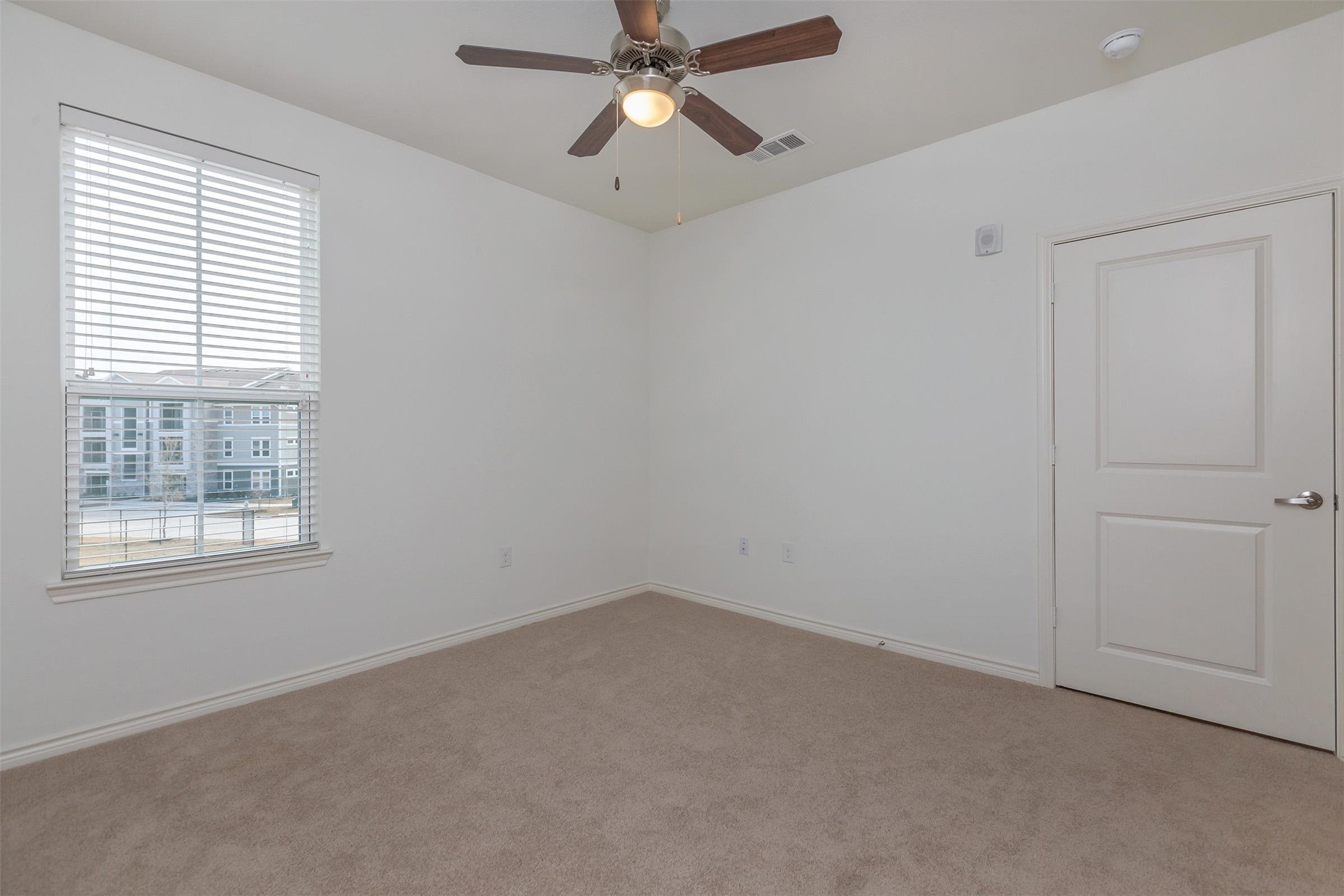 5712 Azle Avenue Fort Worth, TX 76106 - Photo 13 of 15 an empty room with a window and a fan