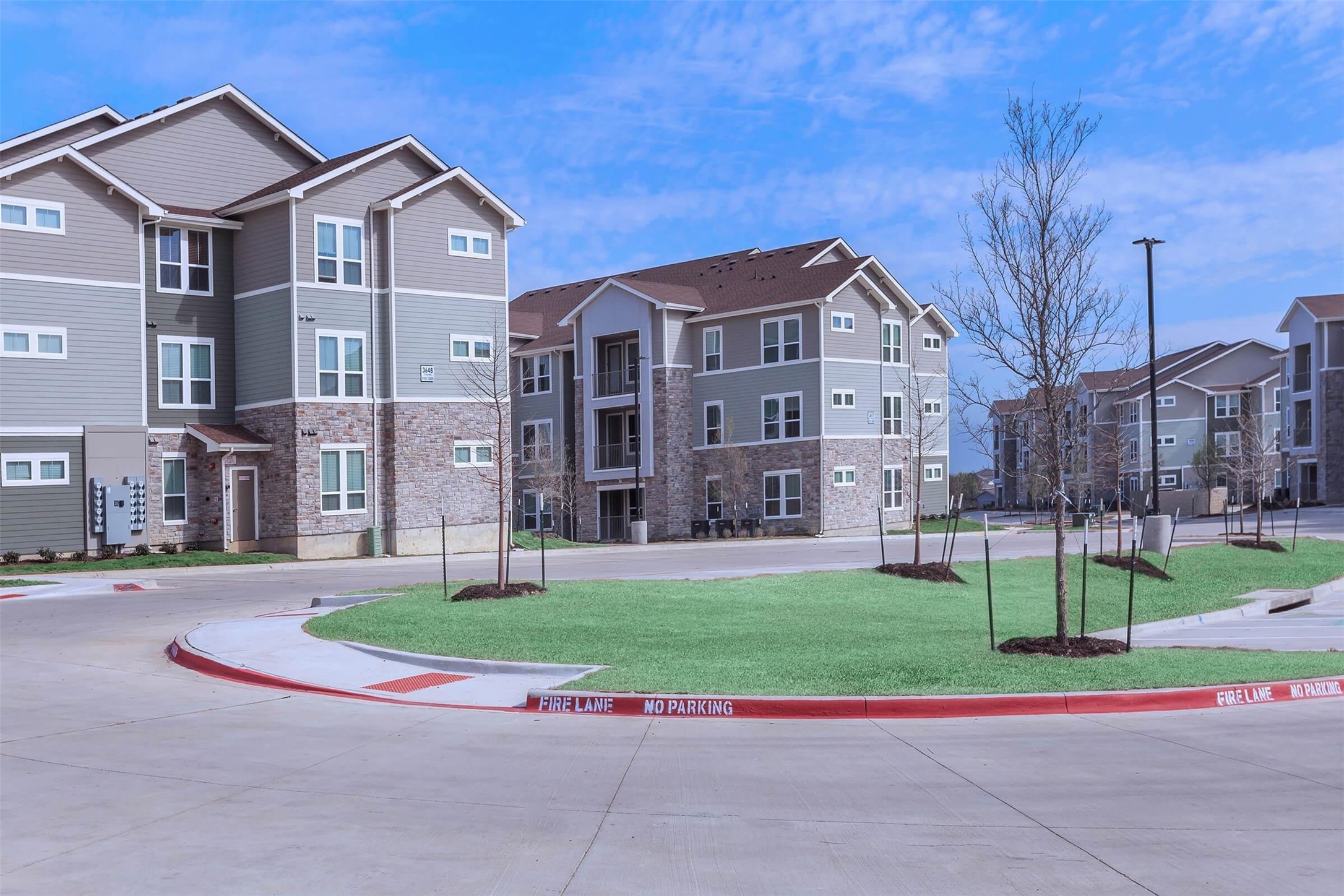 5712 Azle Avenue Fort Worth, TX 76106 - Photo 5 of 15 a view of a large building with a big yard and large trees