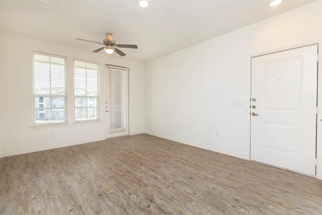 wooden floor in an empty room with a window