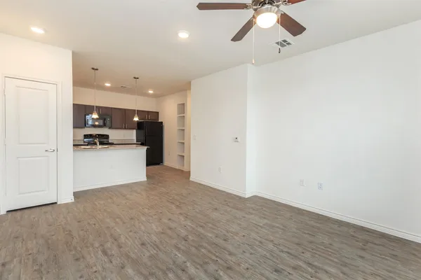 a view of a kitchen with a sink and a refrigerator