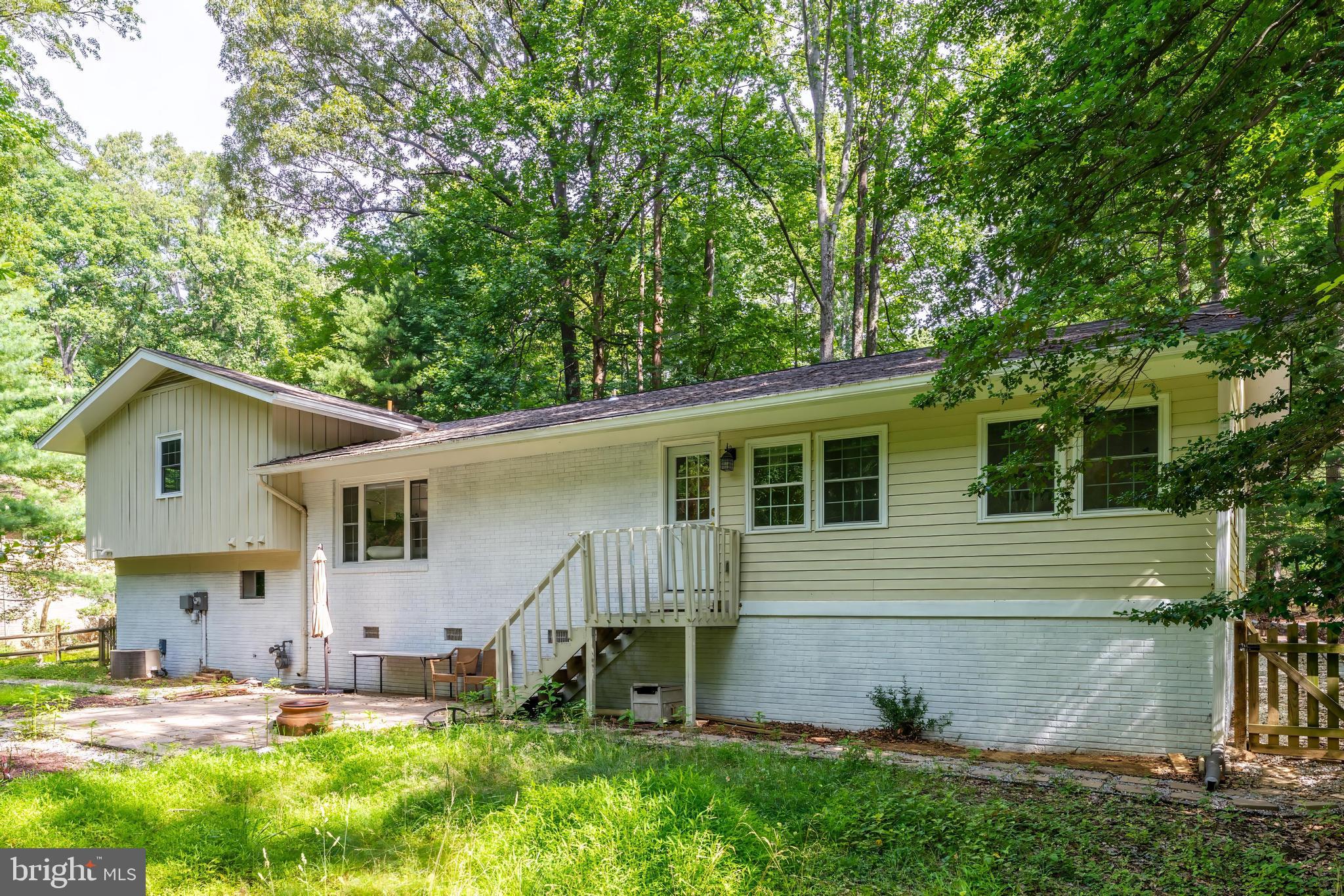 11621 Sourwood Lane Reston, VA 20191 - Photo 5 of 26 a backyard of a house with table and chairs