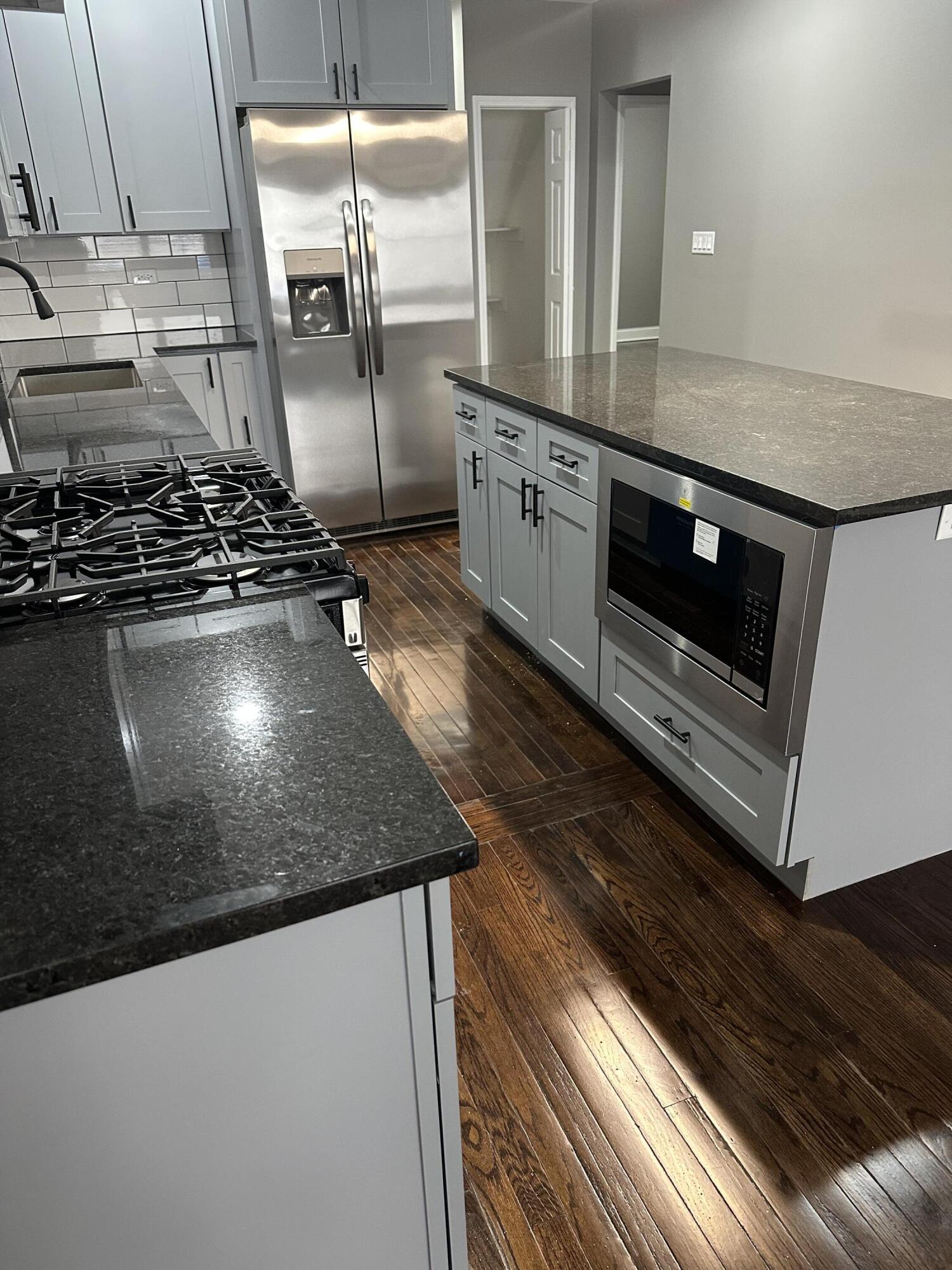 1320 Delaware Street Gary, IN 46407 - Photo 3 of 17 a kitchen with kitchen island a stove and a sink