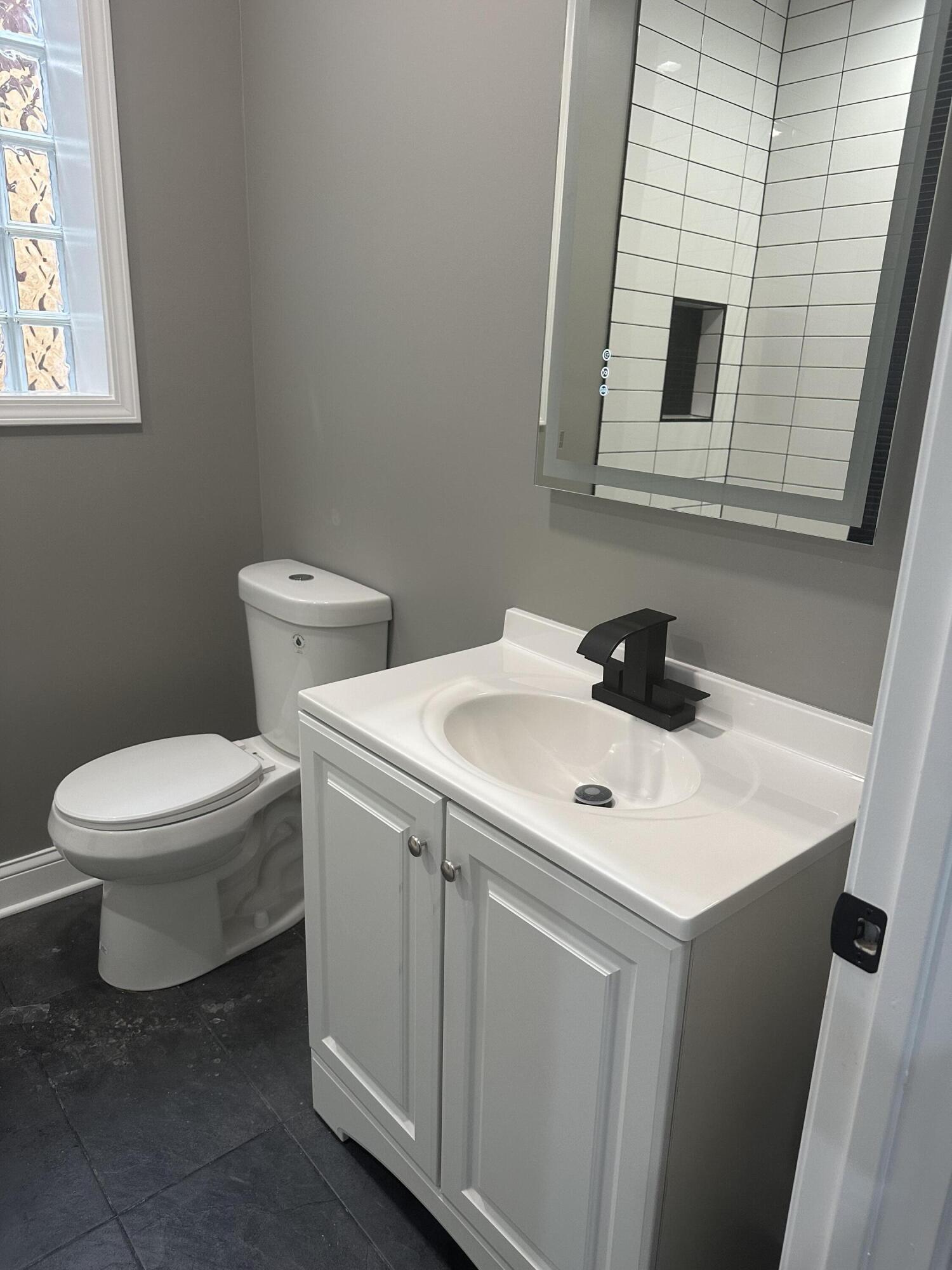 1320 Delaware Street Gary, IN 46407 - Photo 5 of 17 a white toilet sitting next to a bathroom sink