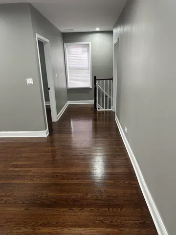 a view of a hallway with hardwood floor