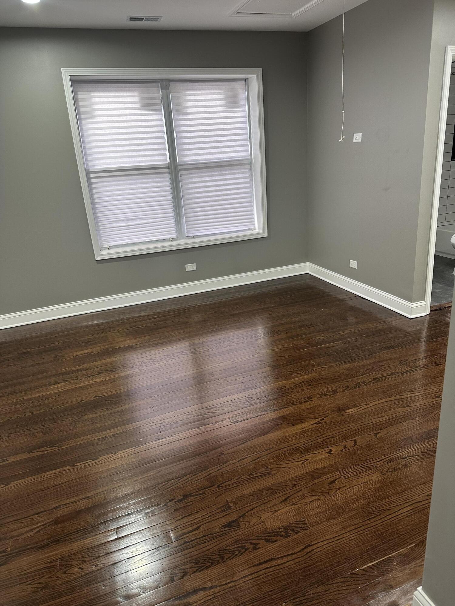 1320 Delaware Street Gary, IN 46407 - Photo 8 of 17 an empty room with wooden floor and windows