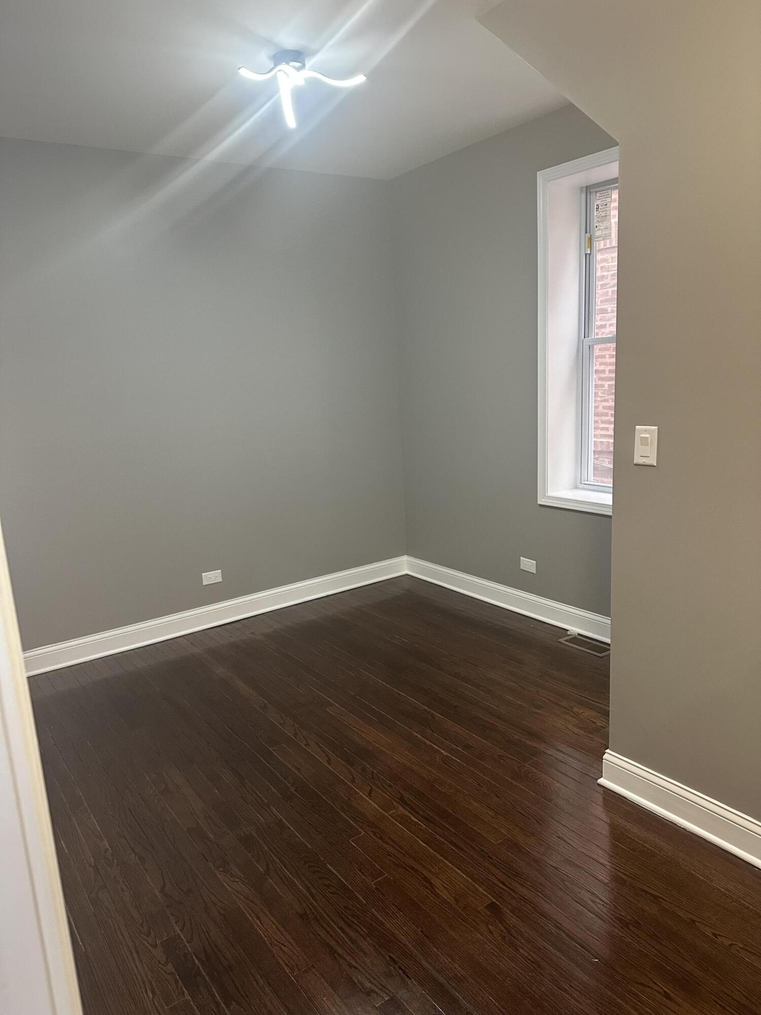 1320 Delaware Street Gary, IN 46407 - Photo 9 of 17 an empty room with wooden floor and windows