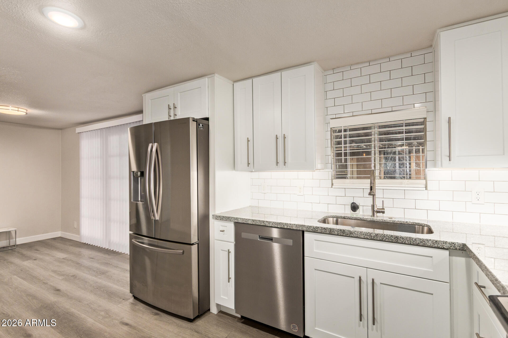 400 West Baseline Road, Unit 312 Tempe, AZ 85283 - Photo 5 of 32 a kitchen with granite countertop a refrigerator sink and cabinets