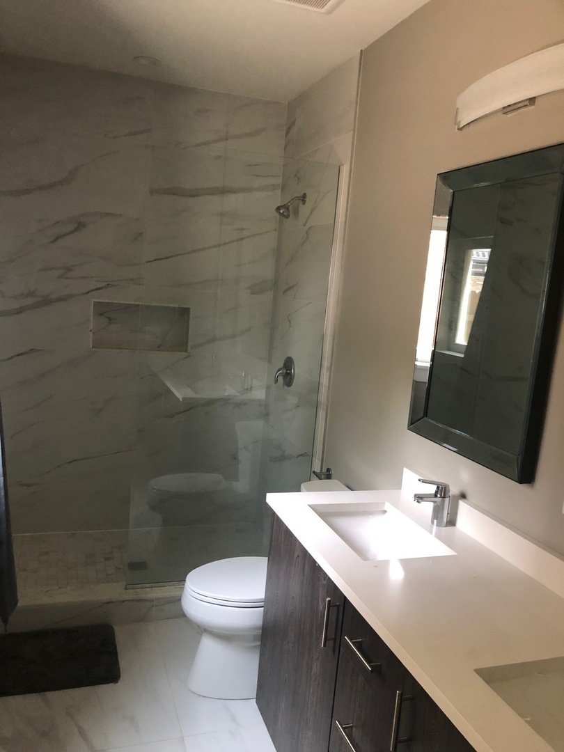 1734 West Cullerton Street, Unit 1 Chicago, IL 60608 - Photo 11 of 12 a bathroom with a sink a toilet and shower