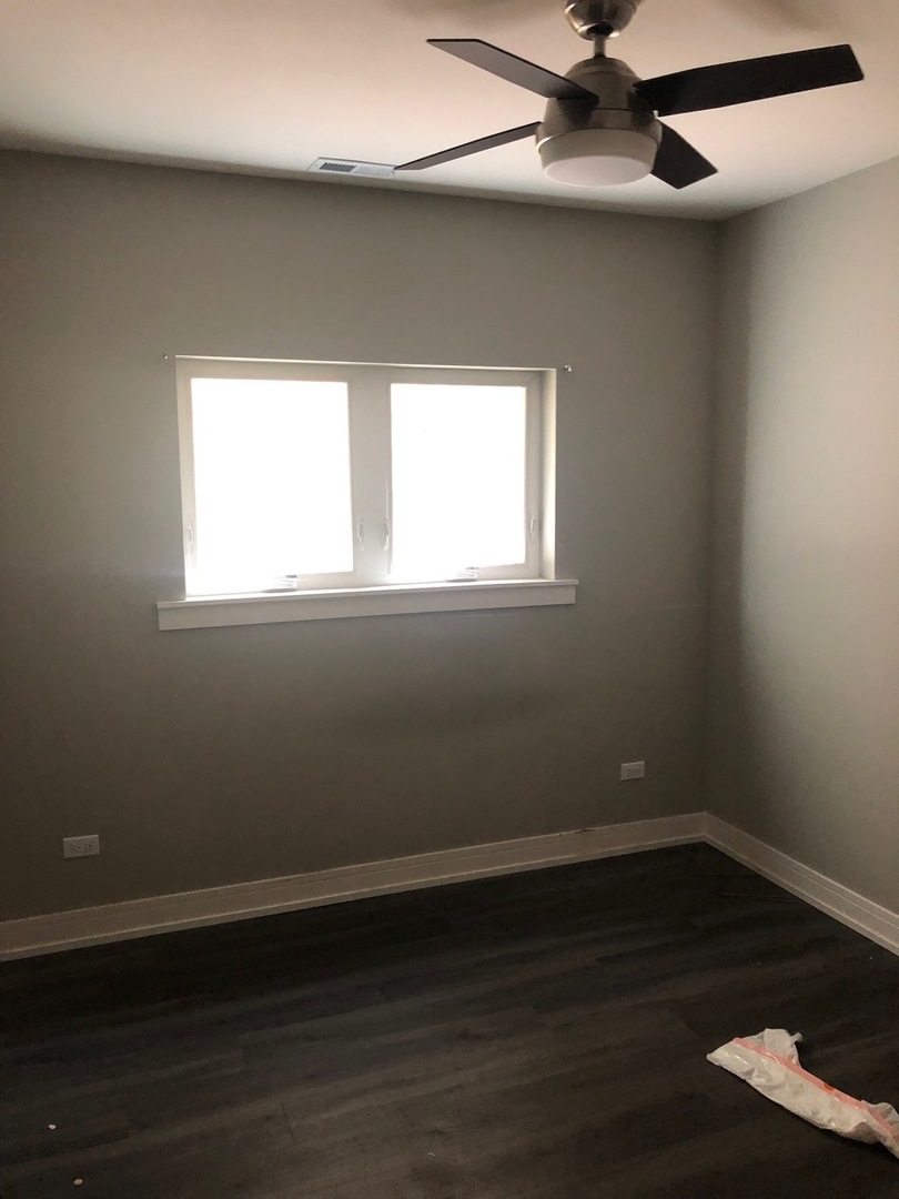 1734 West Cullerton Street, Unit 1 Chicago, IL 60608 - Photo 6 of 12 an empty room with wooden floor and windows