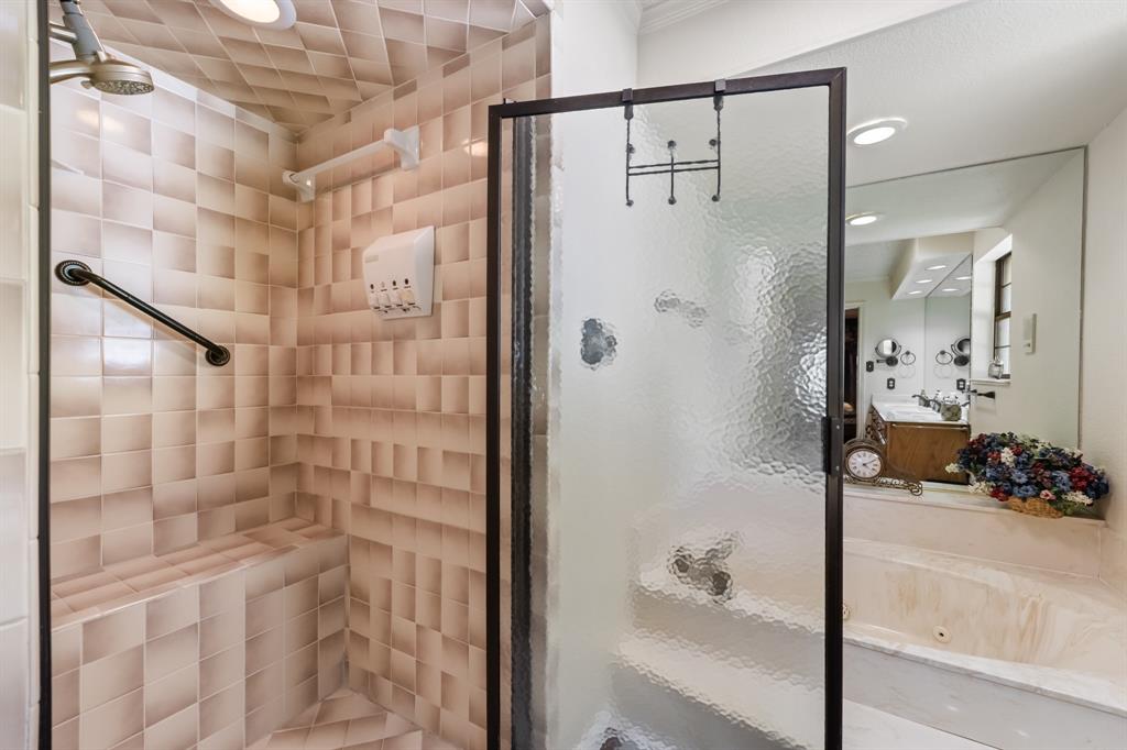 403 Riva Ridge Wylie, TX 75098 - Photo 16 of 32 Shower enclosure with textured glass, tiled walls, built-in shower bench