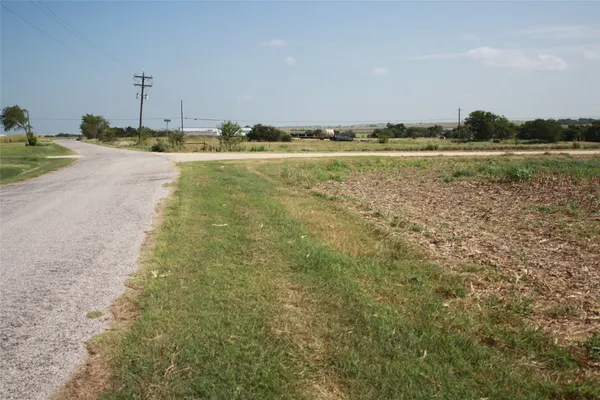 a view of a field with an trees