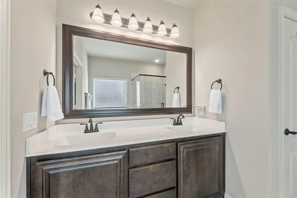 a bathroom with a shower and a sink