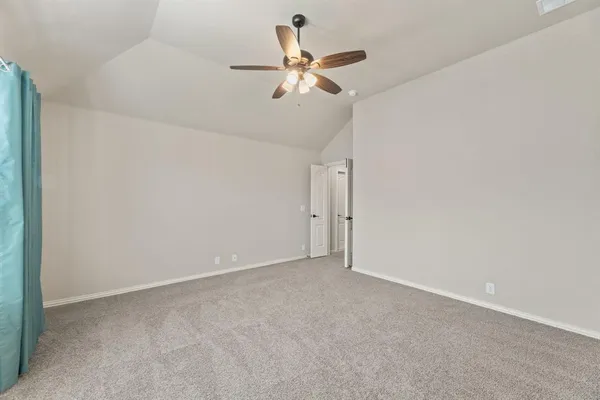 a view of a livingroom with a ceiling fan and window