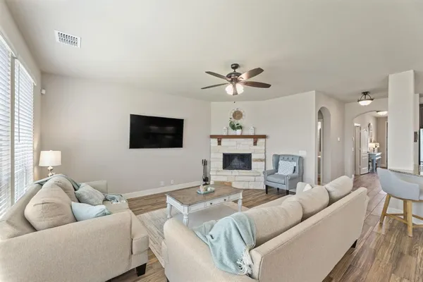 a living room with furniture a fireplace and a flat screen tv