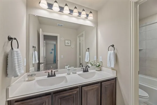 an empty room with window and ceiling fan