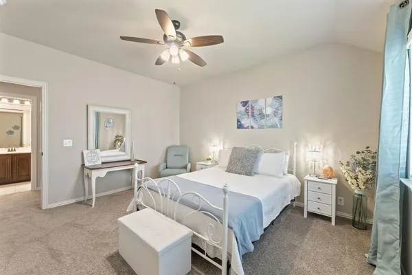 a living room with furniture and a ceiling fan