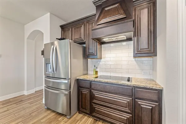 a kitchen with appliances and a refrigerator