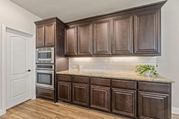 a kitchen with granite countertop stainless steel appliances and cabinets