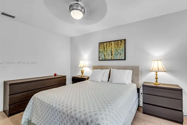 a bedroom with a bed and a night stand