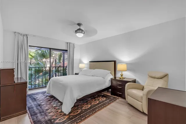 a bedroom with a large bed and a lamp