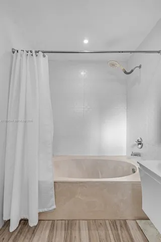 a bathroom with a bathtub and a shower