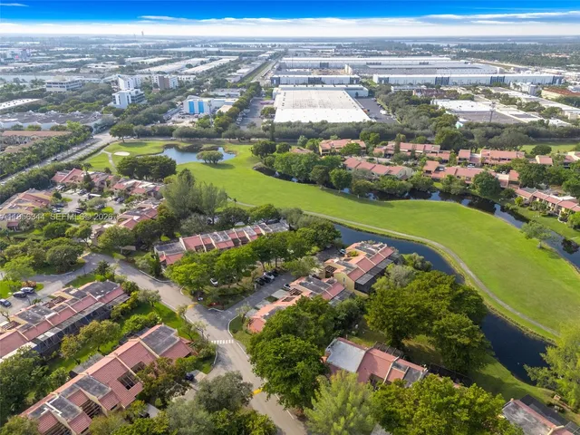 an aerial view of residential building and lake