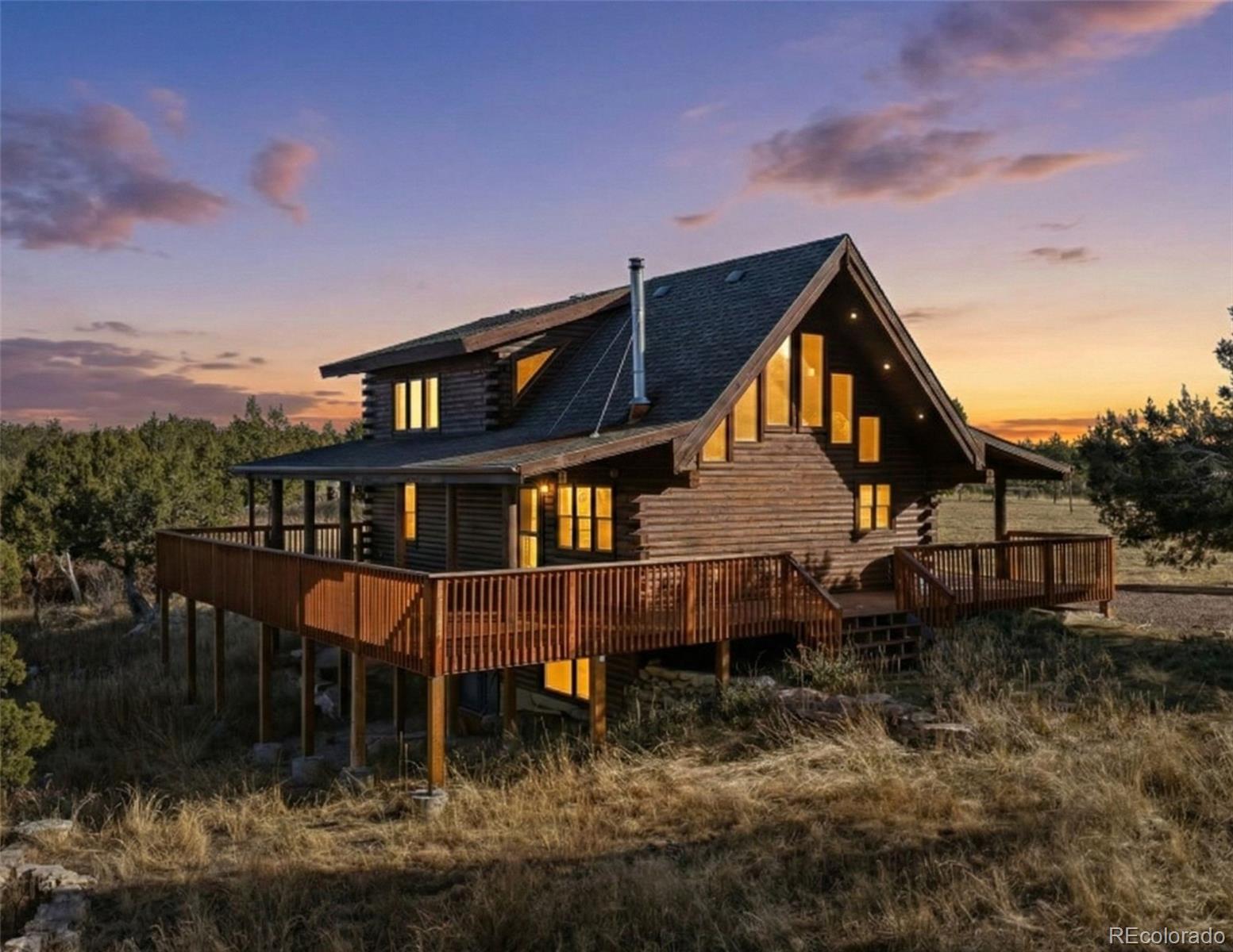 a view of a house with a yard and a deck