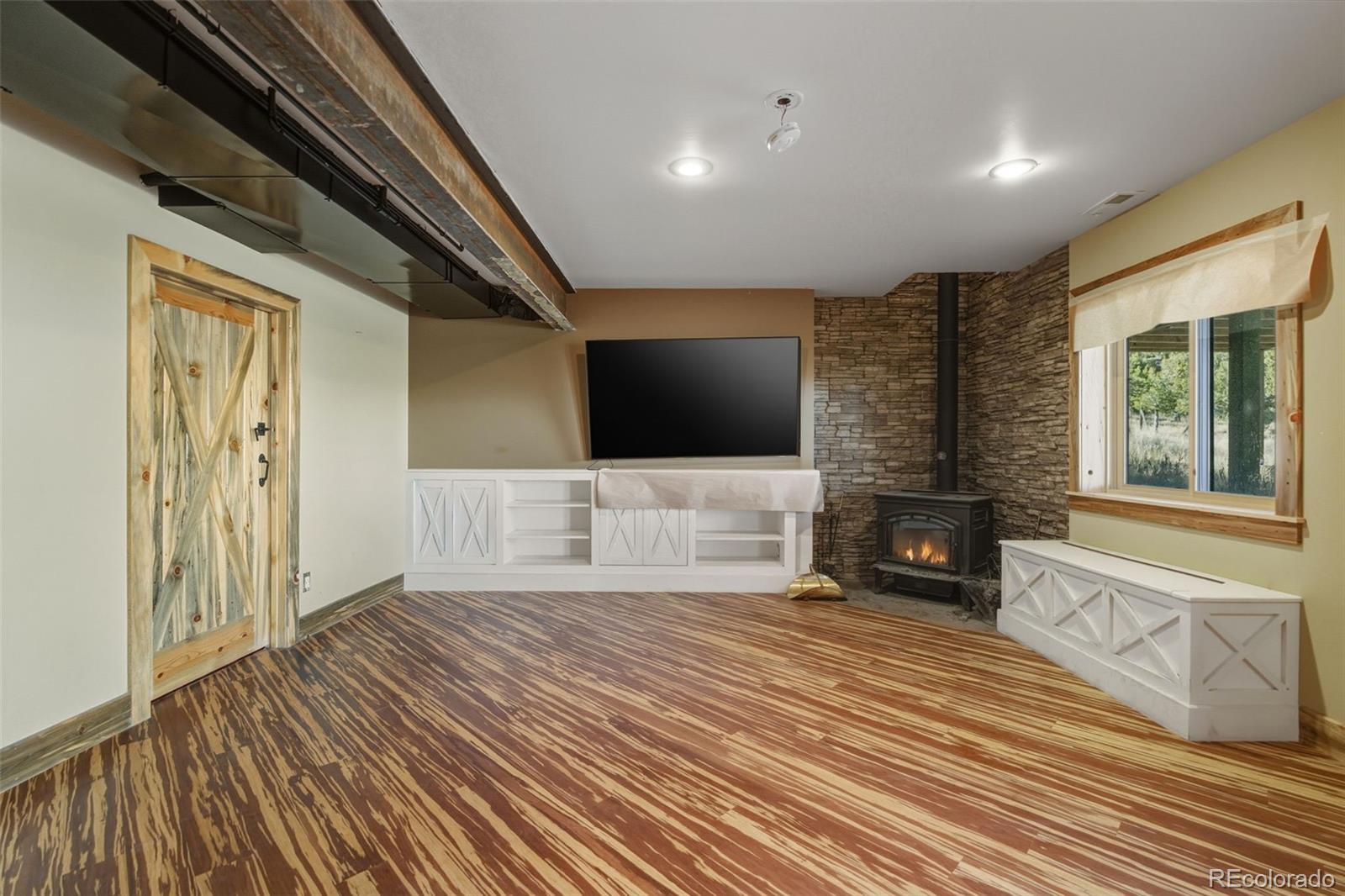 2925 Siloam Road Pueblo, CO 81005 - Photo 27 of 44 a spacious bedroom with a bed and a flat screen tv