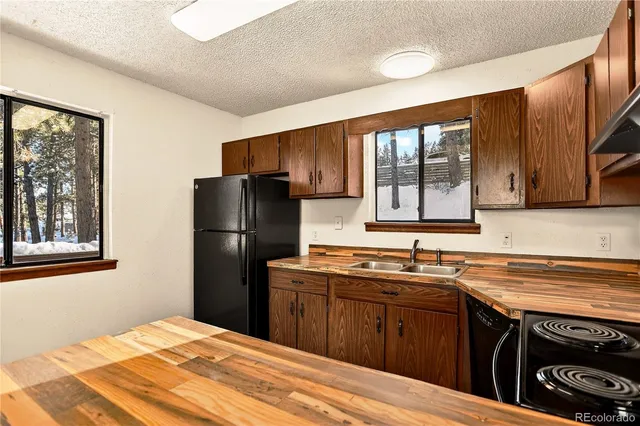 a kitchen with a sink stove and refrigerator